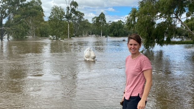 New Warwick resident and firefighter Narelle Couper looks out at the flooded Condamine River, marking her first Rose City flood.