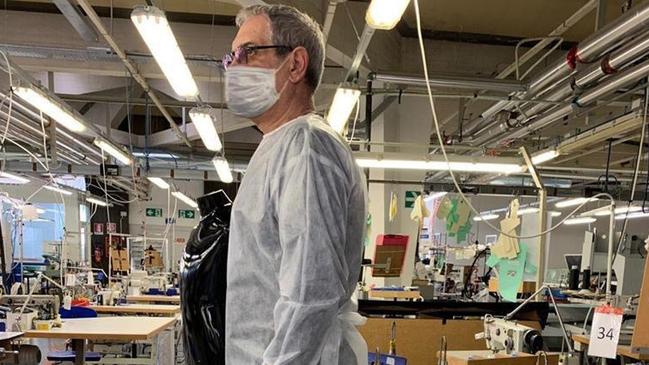 A man wears a medical overall at the Armani factory in Trento, Northern Italy. Picture: AP