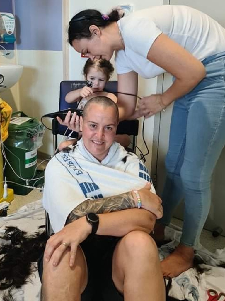 Emerara shaves her aunty Sandy Kennedy 's head with the help of mum Stevee Kennedy.