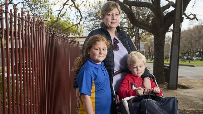 Year 1 student, Lily Romanowicz, 6, with her mother Rebecca Gigney, and brother Hugo, 3, outside Rose Park Primary School, ahead of the teacher strike. Picture: Matt Loxton