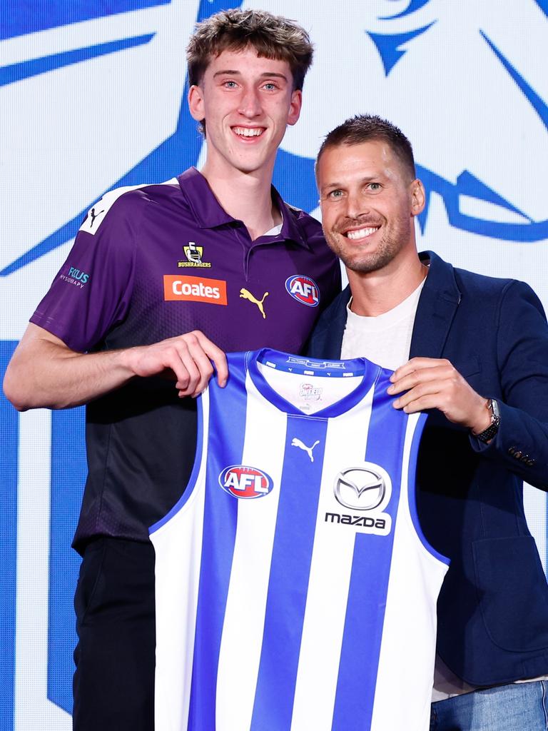 The number 27 pick, Matt Whitlock is presented his North Melbourne Kangaroos jumper by Andrew Swallow. (Photo by Michael Willson/AFL Photos via Getty Images)