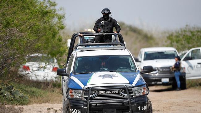 Local police keep watch on tuesday at the scene where authorities found the bodies of two of four Americans kidnapped in Matamoros. Picture: Reuters