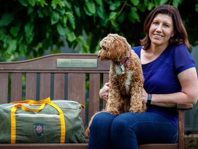 Kellie Harrison with her late husband's fire clothing in a bag sitting on a bench with a plaque in his memory on October 15, 2020, Kellie, whose husband died on Oct 31, 2014 after falling off a farm firefighting truck during a blaze in the Mid North. Picture Matt Turner.