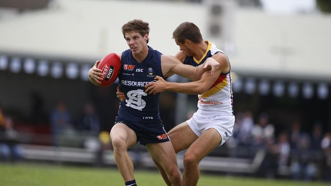 South Adelaide’s Matt Rose tries to evade Crow Jackson Edwards. Picture: Deb Curtis.