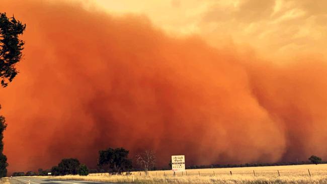 The omnious red dust storm whipped up by strong winds. Picture: Aaron Burnett