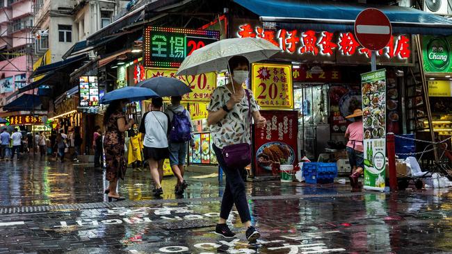 A woman walks through a market in Hong Kong on Saturday. Picture: AFP