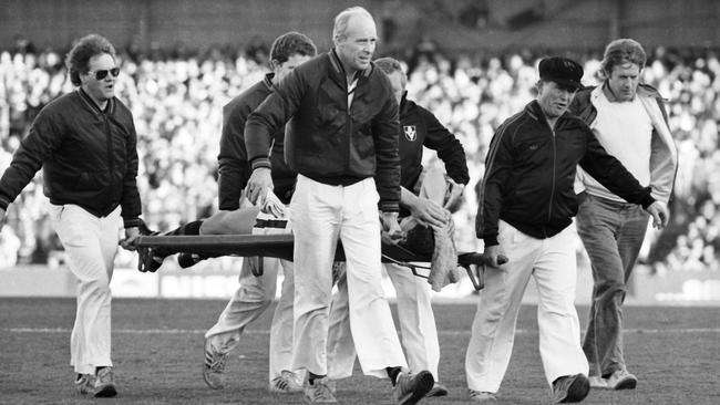 Paul Salmon is carried from the field after injuring his knee.