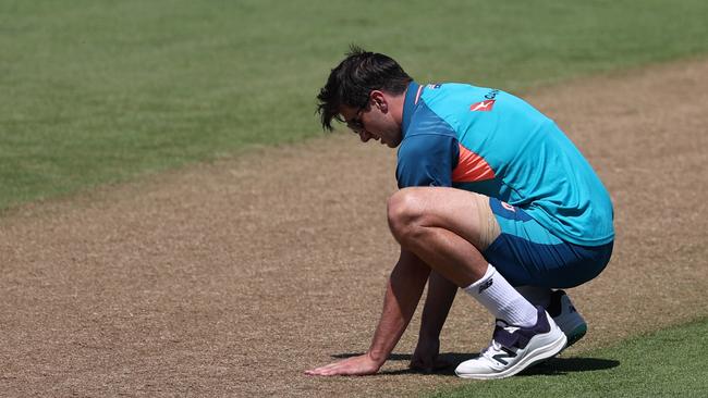 Pat Cummins gets up close and person with the Edgbaston pitch. Photo by Ryan Pierse/Getty Images