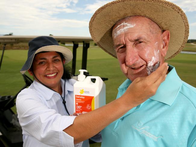 Aruni Ratnayake from Cancer Council NSW helps Lynwood Country Club’s senior member Arthur Graham apply sunscreen. Picture: Justin Sanson