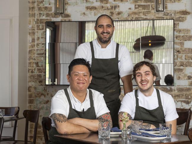 Clove Lane chef -owner Emile Avramides (standing) with Micheal Tran and Eric Valente. Picture: Matthew Vasilescu