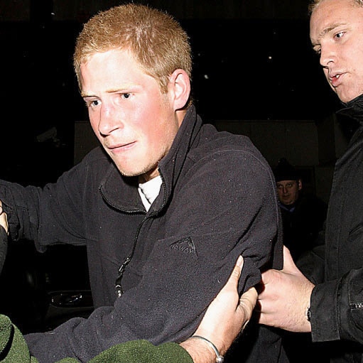 Prince Harry runs past paparazzi outside a London nightclub club in 2005.