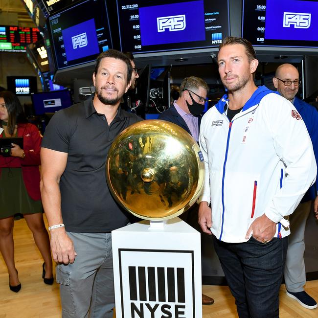 NEW YORK, NEW YORK - JULY 15: Mark Wahlberg (L) and F45 Founder and CEO Adam Gilchrist pose on the trading floor as F45 Training rings the opening bell at the New York Stock Exchange on July 15, 2021 in New York City. (Photo by Noam Galai/Getty Images for F45 Training)