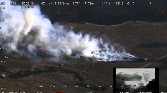 An aerial image shows a fire on Kildare Road in Tenterfield. Aircraft are supporting ground crews to slow the spread of fire and protect homes.