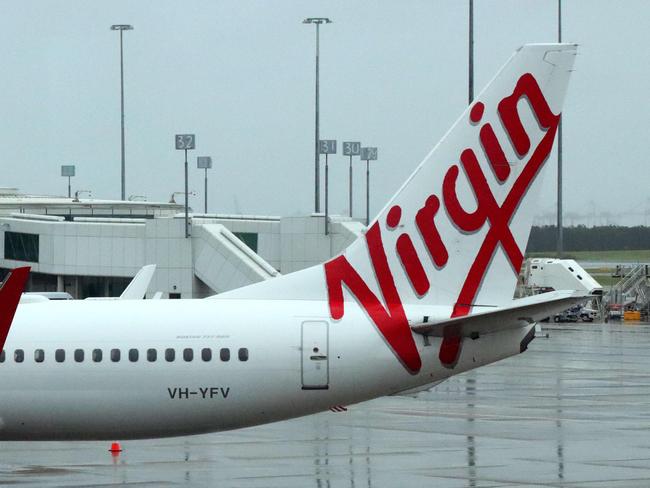 Brisbane Domestic airport photos of the terminal and the Police presence and border pass checking.  Virgin Airlines planes parked at the terminal. Thursday 25th November 2021 Picture David Clark