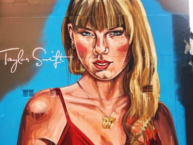 A huge Taylor Swift mural has popped up in Sydney ahead of her arrival for her three shows, but the artwork has received mixed reviews. The large portrait of Swift is on Crown Street in Surry Hills and portrays her wearing a red wrap dress, with her eyes angled downward. Picture: Instagram