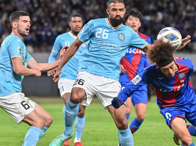 Kofu's Kazushi Mitsuhira (R) tries to head the ball as Melbourne's Samuel Souprayenonal (C) and Steven Ugarkovic (L) defend in front of the goal during the AFC Champions League Group H football match between Japanâs Ventforet Kofu and Australiaâs Melbourne City FC at the National Stadium in Tokyo on November 29, 2023. (Photo by Richard A. Brooks / AFP)