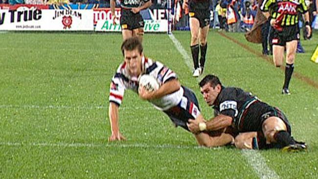 John Sattler’s son Scott makes a match-winning tackle on the Roosters’ Todd Byrne during Penrith’s 2003 NRL grand final success. Photo: Channel Nine.