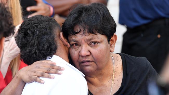 Georgina Rioli hugs family and friends after her husband, Willie Rioli Senior's funeral service in Darwin. Picture: (A)manda Parkinson