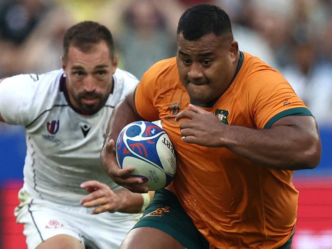 Australia's tighthead prop Taniela Tupou (R) runs with the ball during the France 2023 Rugby World Cup Pool C match between Australia and Georgia at Stade de France in Saint-Denis, on the outskirts of Paris, on September 9, 2023. (Photo by FRANCK FIFE / AFP)