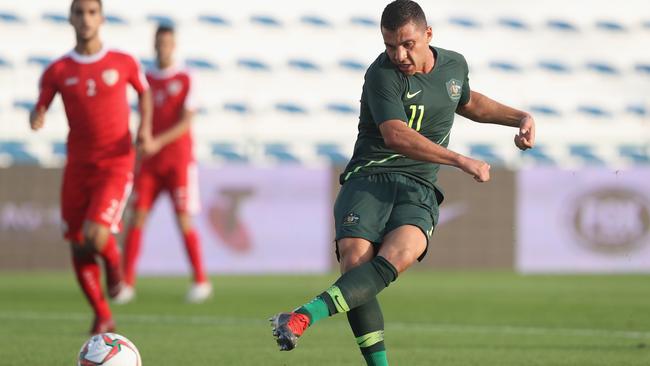 Andrew Nabbout fires home Australia’s first goal in the 10th minute against Oman at Maktoum Bin Rashid Al Maktoum Stadium in Dubai yesterday. Picture: Getty Images