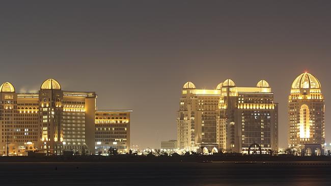 The city of Doha glitters at night.