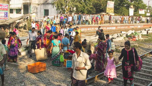 People gather at the train station in Kolkata.