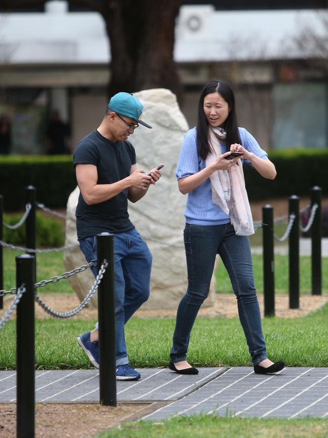 Locals play Pokemon Go at Mawson Park in Campbelltown. Picture: AAP