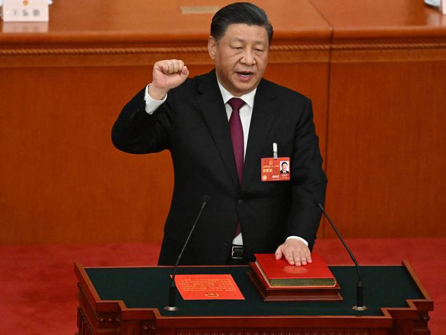 China's President Xi Jinping swears under oath after being re-elected as president for a third term during the third plenary session of the National People's Congress (NPC) at the Great Hall of the People in Beijing on March 10, 2023. (Photo by NOEL CELIS / AFP)