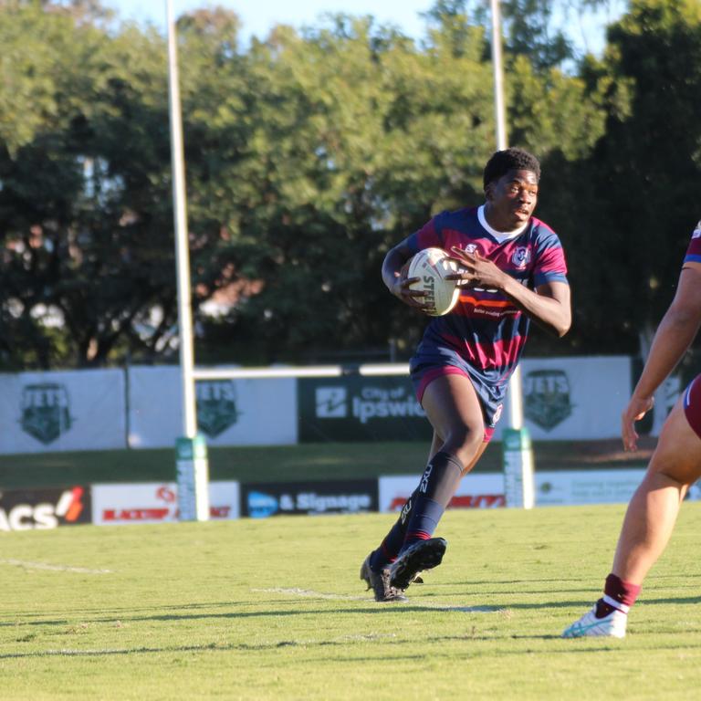 Innocent Baruani running the ball for Ipswich State High last year.