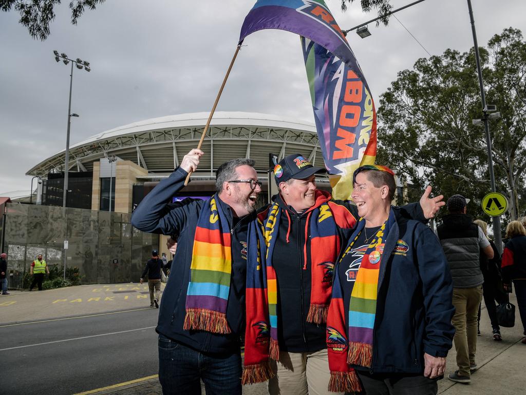 Crows supporters Brett Mcaloney, Megan Harris and Angela Cameron pause for a photo outside the oval before heading into Showdown 45. AAP Image/ Morgan Sette