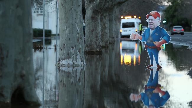 A burst water main in Jeffcott St, North Adelaide threatened to flood houses. A cardboard cut out of Water Minister Ian Hunter at the burst. Picture: Tait Schmaal