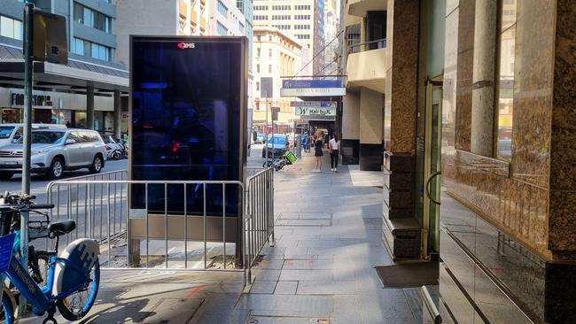 Pedestrians are forced to walk almost single-file to get past this QMS billboard. Picture: Elise Kaine