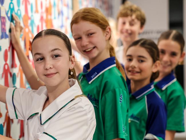 Charlotte Ford, Francesca Novak, Kisty Glen, Ella Marshall and Sam Loncar writing pledges as part of Life Ed Queensland's new campaign to help tackle bullying. Photo: Supplied.