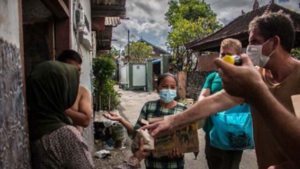 Helping locals in the slums in Denpasar. Picture: Dean Keddell