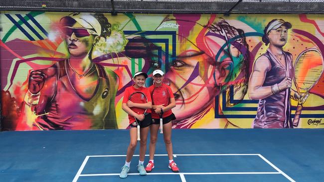 Kelvin Grove State High School tennis players Nicola Schoeman, left and Ella Pittendreigh at the unveiling of murals for Sam Stosur and Ashleigh Barty.