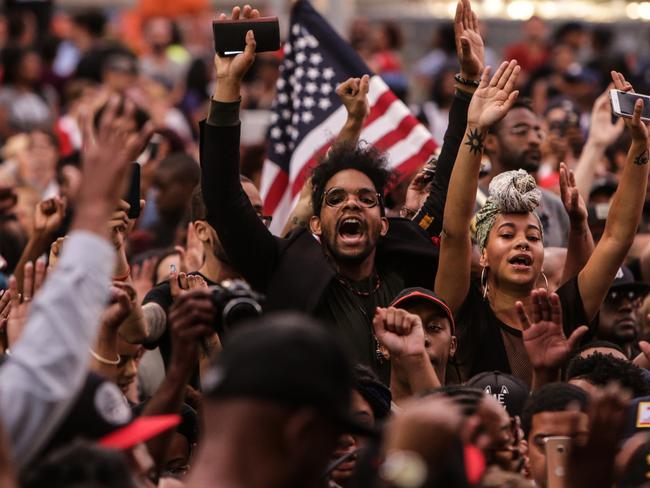 Protesters gather at Campus Martius in Detroit, Friday July 8, 2016, while listening to speakers who were speaking out against the fatal police shootings of Alton Sterling and Philando Castile. (Ryan Garza/Detroit Free Press via AP)