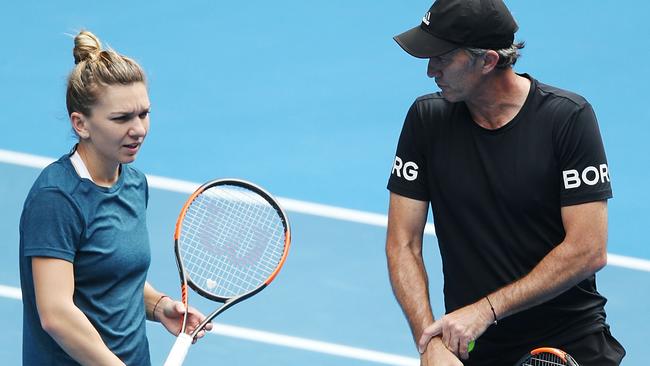 Simona Halep of Romania listens to coach Darren Cahill