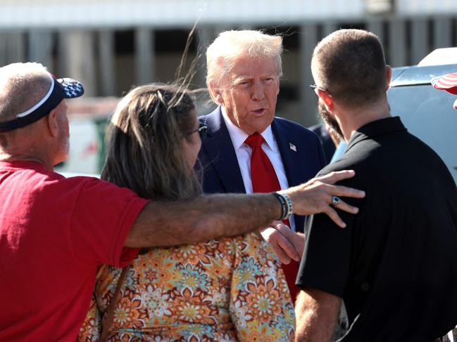 DETROIT, MICHIGAN - OCTOBER 18: Republican presidential nominee, former U.S. President Donald Trump, greets supporters as he arrives at Detroit Metropolitan Wayne County Airport on October 18, 2024, in Detroit, Michigan. There are 17 days remaining until the U.S. presidential election, which will take place on Tuesday, November 5, 2024.   Win McNamee/Getty Images/AFP (Photo by WIN MCNAMEE / GETTY IMAGES NORTH AMERICA / Getty Images via AFP)