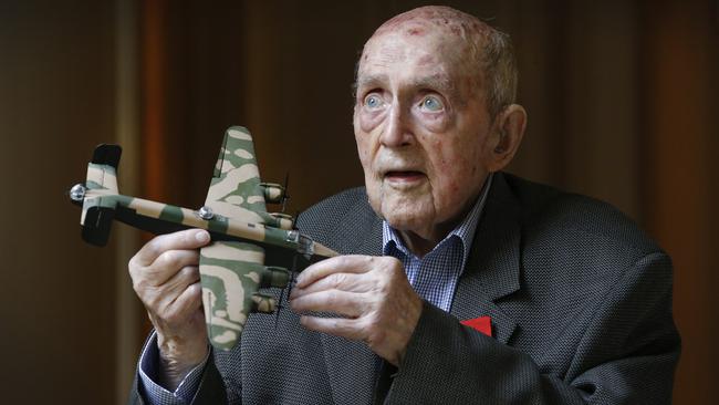 WWII veteran bomber pilot Laurie Larmer 98, holds a model of a Halifax bomber that he flew during the war. Picture: David Caird.