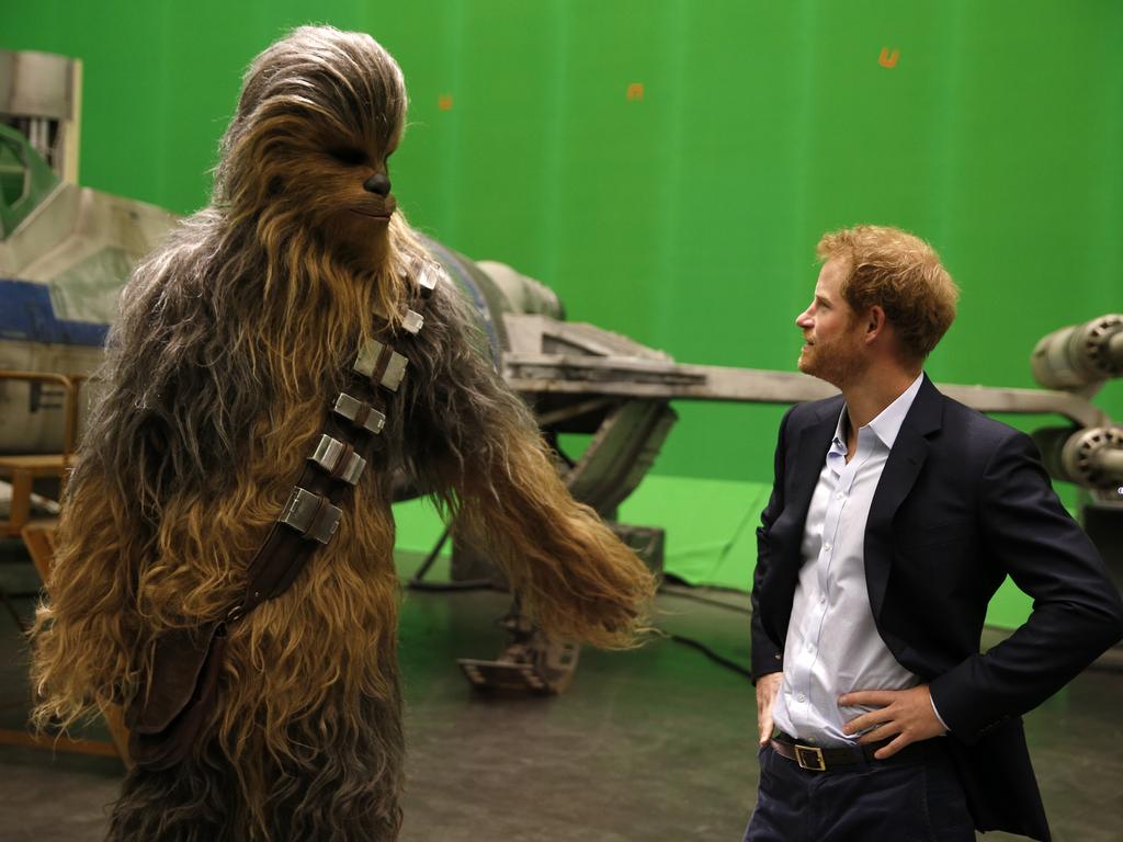 Prince Harry meets Chewbacca during a tour of the Star Wars sets at Pinewood studios on April 19, 2016 in Iver Heath, England. Picture: Getty