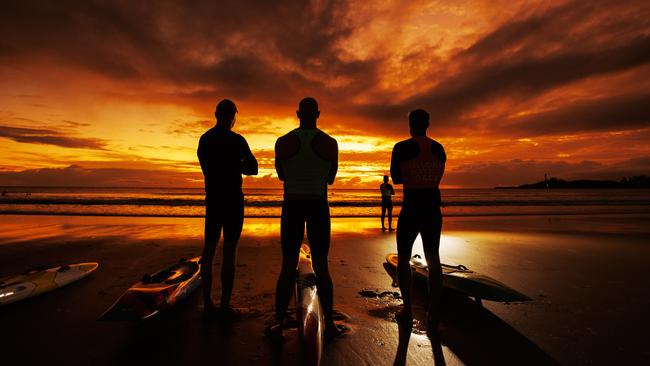 Mooloolaba Surf Club board riders make the most of the winter solstice by hitting the water at sunrise. Picture Lachie Millard