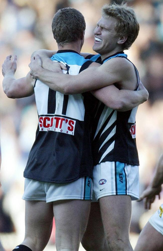 Kane Cornes hugs Damien Hardwick after Port Adelaide won the 2004 AFL grand final.