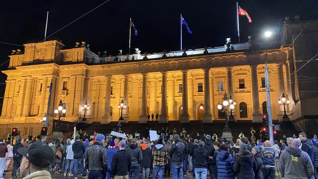 Anti-lockdown protesters on the steps of state parliament.