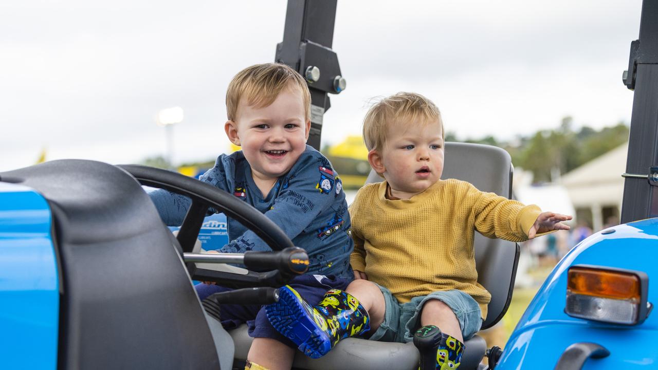 Vinnie Hannant (left) and Sonny Leek check out one of the tractors on display at the 2022 Toowoomba Royal Show, Friday, March 25, 2022. Picture: Kevin Farmer