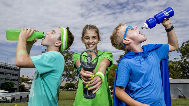 Benowa State School students Riley Eskersley, 11, Charlotte Smith, 11, and Nick Bouwmeester, 11, are hot under the sun after running their school cross country on a hot Autumn day. Picture: Jerad Williams