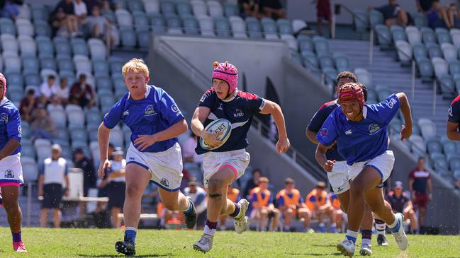 Hugh Stanbury storms through a gap. Buildcorp Emerging Reds Cup action from the day one match between Queensland Country Under-14s and Brisbane Junior Rugby Union Under-14s. Picture credit: QRU Media/ Erick Lucero.