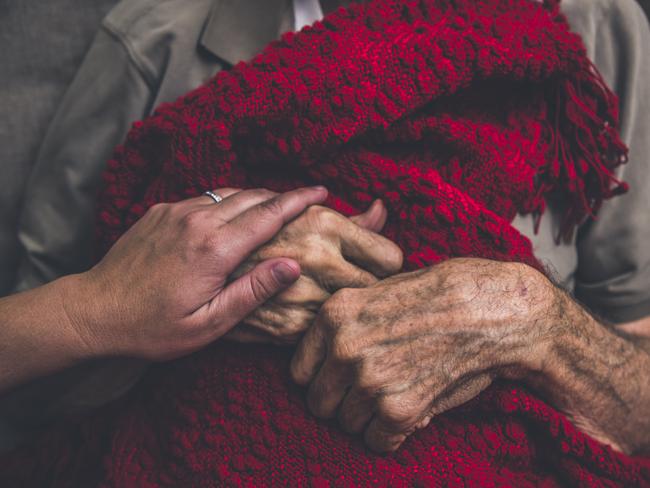 A stock photo of a Hospice Nurse visiting an Elderly male patient who is receiving hospice/palliative care.