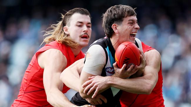 ADELAIDE, AUSTRALIA - MAY 07: Sam Draper of the Bombers tackles Zak Butters of the Power during the 2023 AFL Round 08 match between the Port Adelaide Power and the Essendon Bombers at Adelaide Oval on May 7, 2023 in Adelaide, Australia. (Photo by James Elsby/AFL Photos via Getty Images)