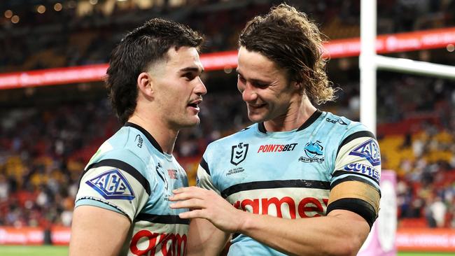 BRISBANE, AUSTRALIA - MAY 18: Daniel Atkinson and Nicho Hynes of the Sharks celebrate victory during the round 11 NRL match between Cronulla Sharks and Sydney Roosters at Suncorp Stadium, on May 18, 2024, in Brisbane, Australia. (Photo by Hannah Peters/Getty Images)