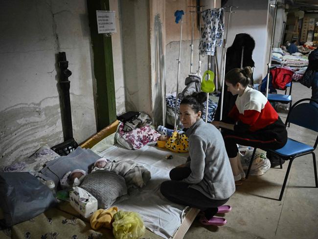 Women look after their babies at the paediatrics centre after the unit was moved to the basement of the hospital which is being used as a bomb shelter, in Kyiv. Picture: AFP